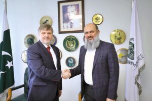 Federal Minister for Commerce Jam Kamal Khan and SPIMEX Vice President Dmitriy Chernyshev shake hands after a meeting on strengthening Pakistan-Russia trade ties