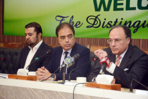 The Federal Finance Minister, Muhammad Aurangzeb receiving a souvenir shield from SVP Federation of Pakistan Chambers of Commerce and Industry Saqib Fayaz Magoon during a visit of FPCCI Head office