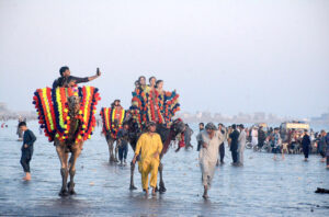 Children enjoying camel ride at sea view beach Clifton, on the 2nd day of Eid-ul-Fitr celebrations