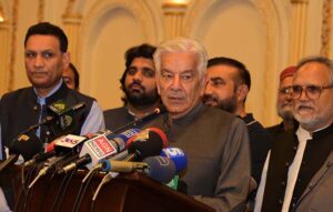 Defense Minister Khawaja Muhammad Asif addressing PML-N workers during the Eid Milan party