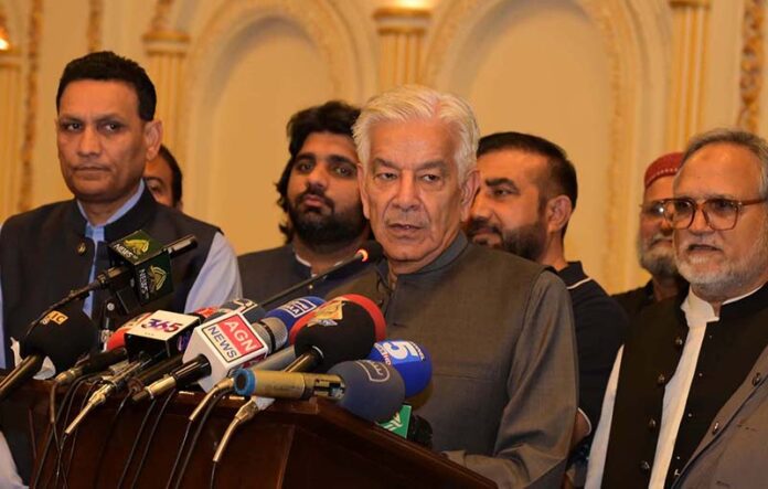 Defense Minister Khawaja Muhammad Asif addressing PML-N workers during the Eid Milan party
