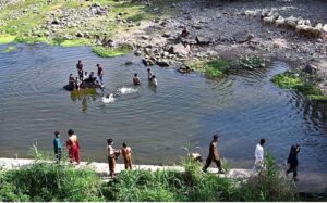 Teenagers swimming in the refreshing waters of Korang Nala to beat the heat in the heart of federal capital on a hot day.