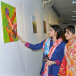 Female art enthusiasts admire the artwork on display during the Punjab Culture Day event, organized by the Information and Culture Department at Multan Arts Council