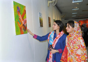 Female art enthusiasts admire the artwork on display during the Punjab Culture Day event, organized by the Information and Culture Department at Multan Arts Council