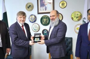 Federal Minister for Commerce Jam Kamal Khan and SPIMEX Vice President Dmitriy Chernyshev shake hands after a meeting on strengthening Pakistan-Russia trade ties