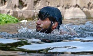 Teenagers swimming in the refreshing waters of Korang Nala to beat the heat in the heart of federal capital on a hot day.