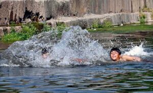 Teenagers swimming in the refreshing waters of Korang Nala to beat the heat in the heart of federal capital on a hot day.