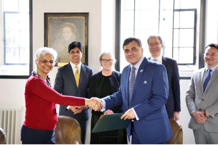 High Commissioner of Pakistan to UK, Dr. Mohammad Faisal and Professor Shailaja Fennel of the Center for South Asian Studies - University of Cambridge, UK exchanging MOU documents for establishment of 