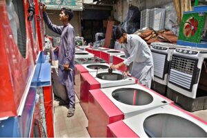 Workers busy preparing room coolers at their workplace to meet the rising demand during the summer season