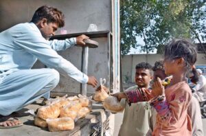 Girl receiving free meal from an NGO JDC at Korangi area.