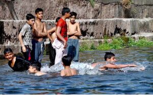 Teenagers swimming in the refreshing waters of Korang Nala to beat the heat in the heart of federal capital on a hot day.