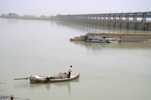 A fisherman fishing on his boat at Indus river