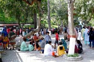 Children enjoy the artificial dolphin water slide at the zoo on the third Eid-ul-Fitr celebrations in the city