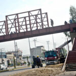 Workers engaged in repair work at Defence Bridge to improve pedestrian convenience in the provincial capital