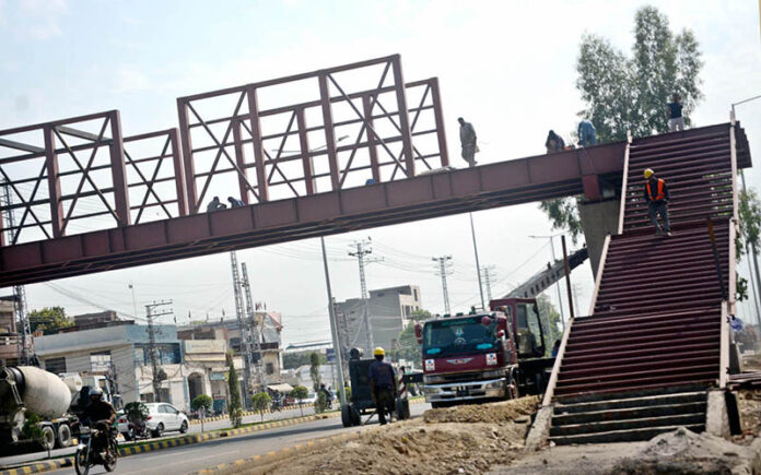 Workers engaged in repair work at Defence Bridge to improve pedestrian convenience in the provincial capital