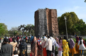 Children enjoy the artificial dolphin water slide at the zoo on the third Eid-ul-Fitr celebrations in the city