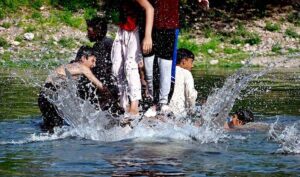 Teenagers swimming in the refreshing waters of Korang Nala to beat the heat in the heart of federal capital on a hot day.