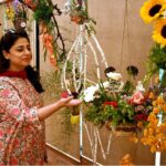 A nature lover admires the beautiful floral displays at the 76th Annual Flower Show 2025, organized by Attock Oil Group of Companies at Morgah Club