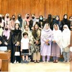 A group photograph of the students and faculty members from Government Postgraduate College for Women Haripur in the senate hall at Parliament House