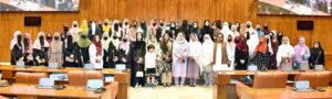 A group photograph of the students and faculty members from Government Postgraduate College for Women Haripur in the senate hall at Parliament House