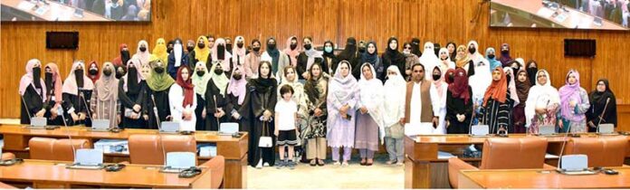 A group photograph of the students and faculty members from Government Postgraduate College for Women Haripur in the senate hall at Parliament House