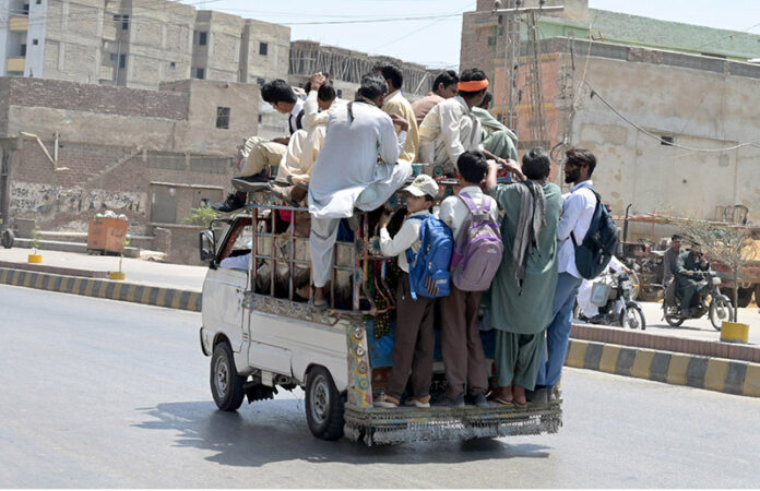 Large number of passengers traveling on rooftop of Suzuki at Jail Road needs the attention of concerned authorities