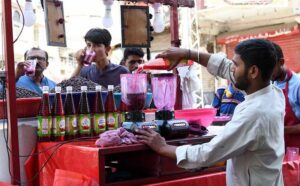A vendor selling traditional summer drink at Pakistan Chowk during scorching hot weather in the city