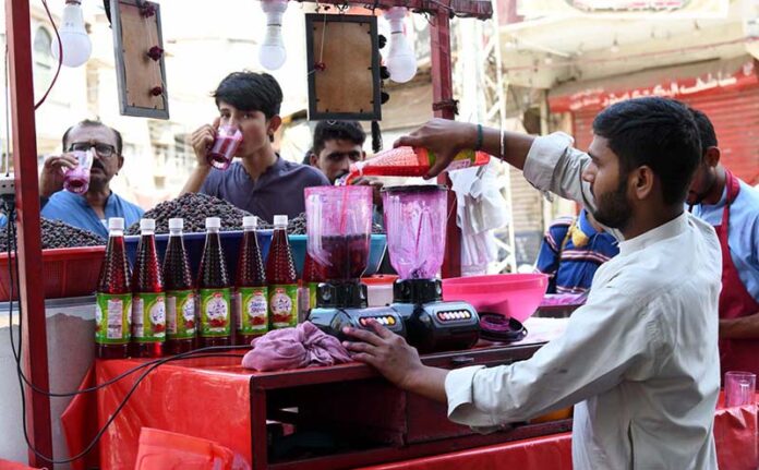 A vendor selling traditional summer drink at Pakistan Chowk during scorching hot weather in the city