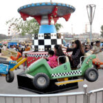 Children enjoying the mechanical swings during 3rd day of Eid-ul-Fitr celebrations at Funland