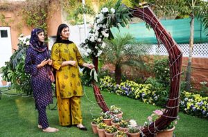 A nature lover admires the beautiful floral displays at the 76th Annual Flower Show 2025, organized by Attock Oil Group of Companies at Morgah Club