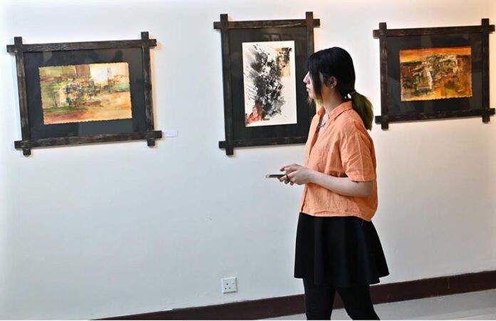 An art lover visits the art exhibition “Rekingdling: The Kalash Narrative,” by six accomplished artists, Ahmed Habib, Akram Dost Baloch, Ejaz Khan, M.A.Bhatti, Riffat Khattak and Samreen Asif organized by Pakistan National Council of the Arts in collaboration with Nomad Gallery at Gallery 06 in PNCA