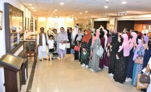 A group photograph of the students and faculty members from Government Postgraduate College for Women Haripur in the senate hall at Parliament House