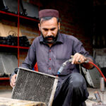An autos mechanic repairs vehicles' radiators at New Shoba Market, keeping engines summer-ready