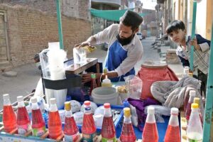 A street vendor selling colorful Ice Gola at Tewana Park in the street of the city