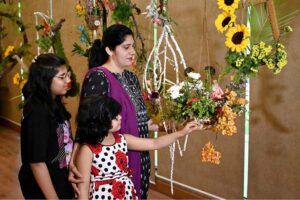 A nature lover admires the beautiful floral displays at the 76th Annual Flower Show 2025, organized by Attock Oil Group of Companies at Morgah Club