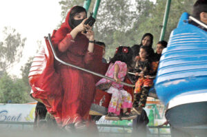 Children enjoying the mechanical swings during 3rd day of Eid-ul-Fitr celebrations at Funland