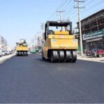 A road roller operates during road construction work on College Road as part of ongoing development efforts to enhance the city's infrastructure