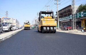 A road roller operates during road construction work on College Road as part of ongoing development efforts to enhance the city's infrastructure
