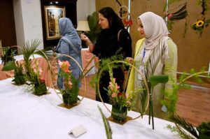 A nature lover admires the beautiful floral displays at the 76th Annual Flower Show 2025, organized by Attock Oil Group of Companies at Morgah Club