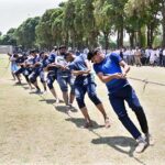 Players exert their full strength as they pull the rope during the final tug-of-war competition between the Sociology Department and the Sports Science Department at the University of Sargodha's Sports Gala