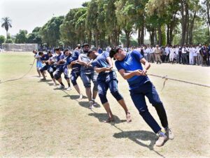 Players exert their full strength as they pull the rope during the final tug-of-war competition between the Sociology Department and the Sports Science Department at the University of Sargodha's Sports Gala