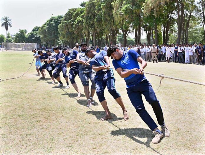 Players exert their full strength as they pull the rope during the final tug-of-war competition between the Sociology Department and the Sports Science Department at the University of Sargodha's Sports Gala