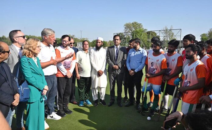 Dutch hockey legend Floris Jan Bovelander provides coaching tips to hockey players during a special training clinic organized by the Khawaja Junaid Hockey Academy (KJHA) at Naseer Bunda Hockey Stadium, Pakistan Sports Complex