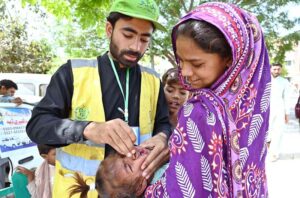 A health department official administers polio drops at Civil Hospital Sargodha during a polio campaign.