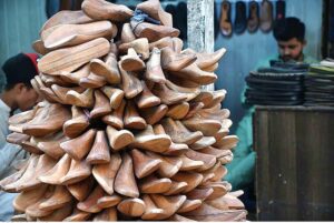A whole seller displaying and selling the footwear wooden frames using for preparing the different kinds of shoes at their shops at local market in the Provincial Capital.