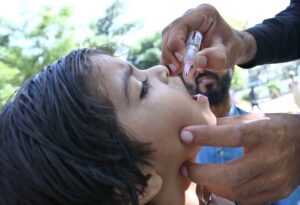A health department official administers polio drops at Civil Hospital Sargodha during a polio campaign.