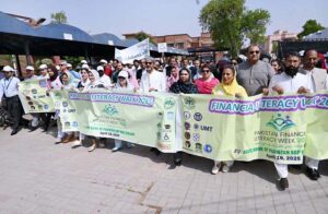 Participants take part in the Financial Literacy Walk 2025 at Government College Women University.