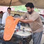 A vendor prepares traditional food Item kutlama to attract customers at his roadside setup