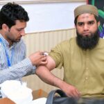 Health Department staff at the Hajj Camp of the Ministry of Religious Affairs, Government of Pakistan, administers vaccinations to Hajj pilgrims to protect them against diseases