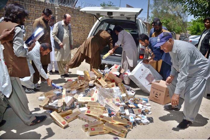 Illegal platinum cigarettes being torched by FBR personnel which was recovered during checking